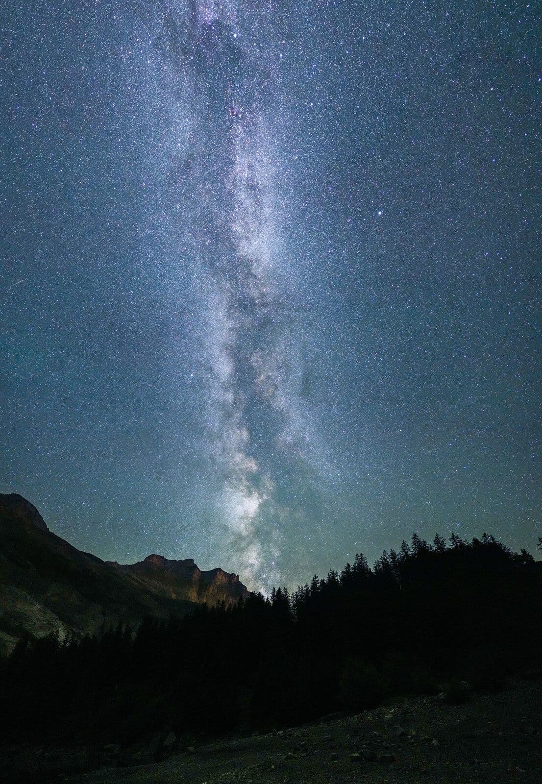 The Milky Way turning over dark mountains