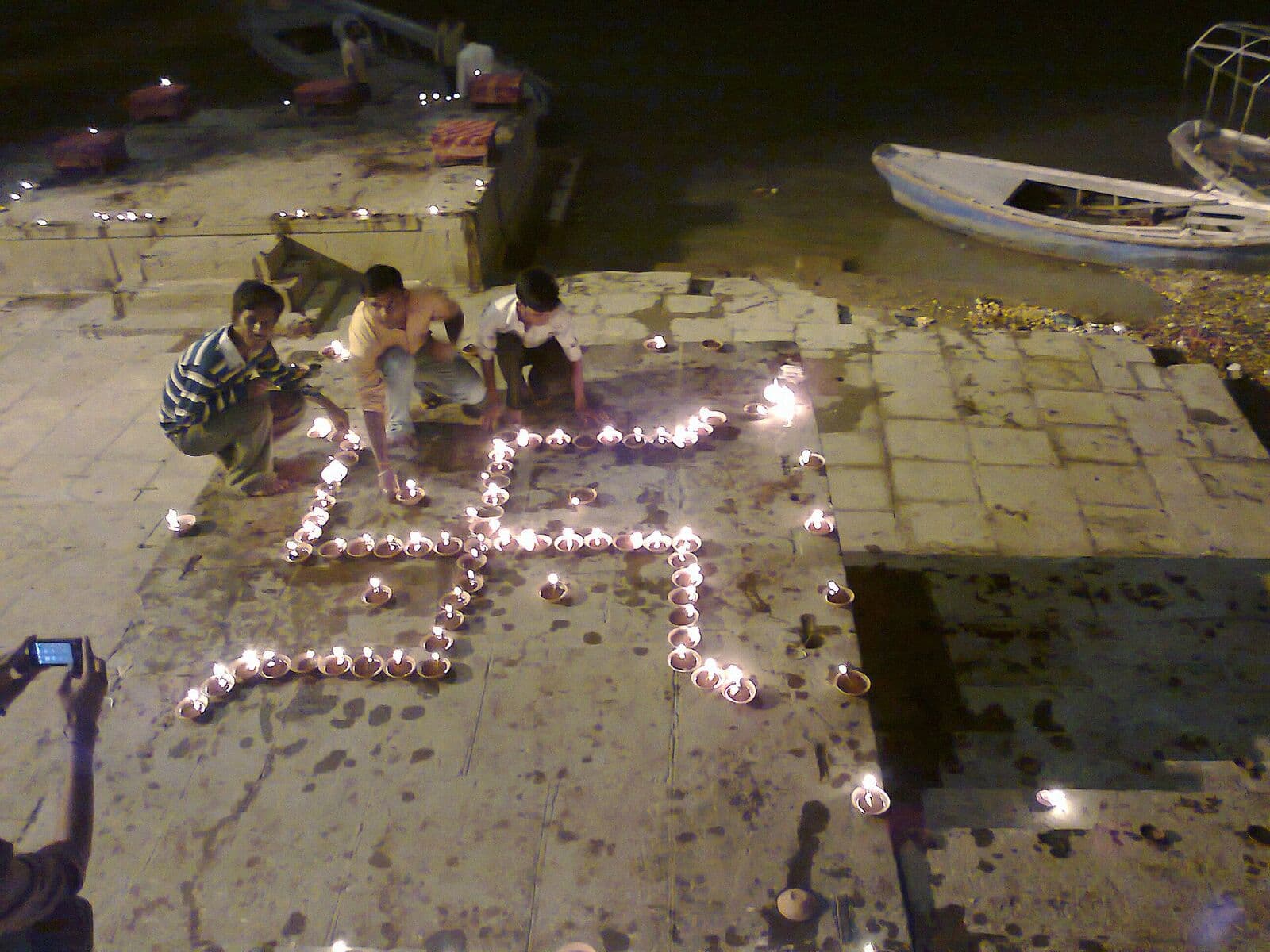 Clay diyas arranged on the ghats on a festival night